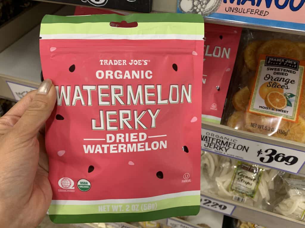 watermelon jerky in packaging at the store against a dark bacgkround
