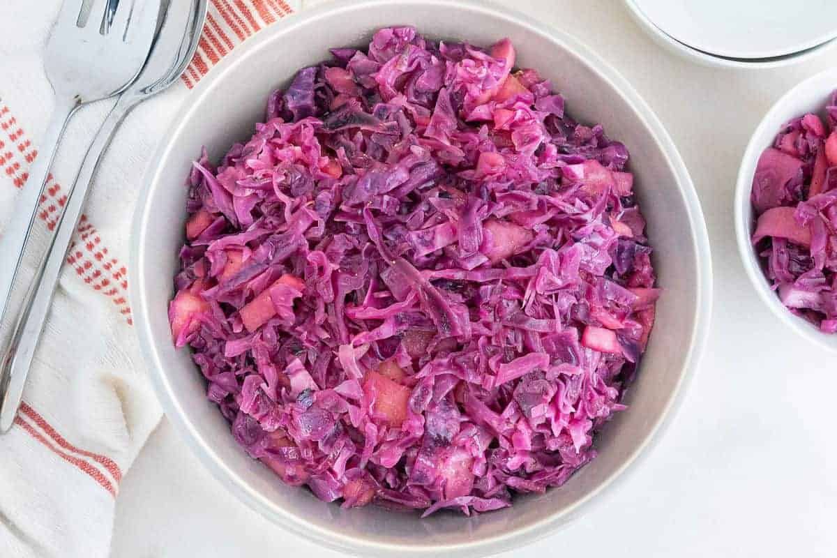 finished sweet and sour red cabbage in a white bowl against a white background