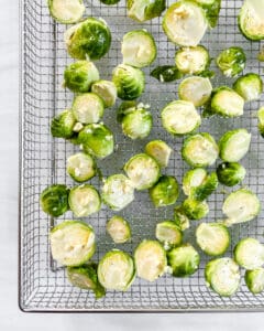brussels sprouts spread out on a wire rack