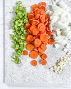 sliced veggies on a white cutting board