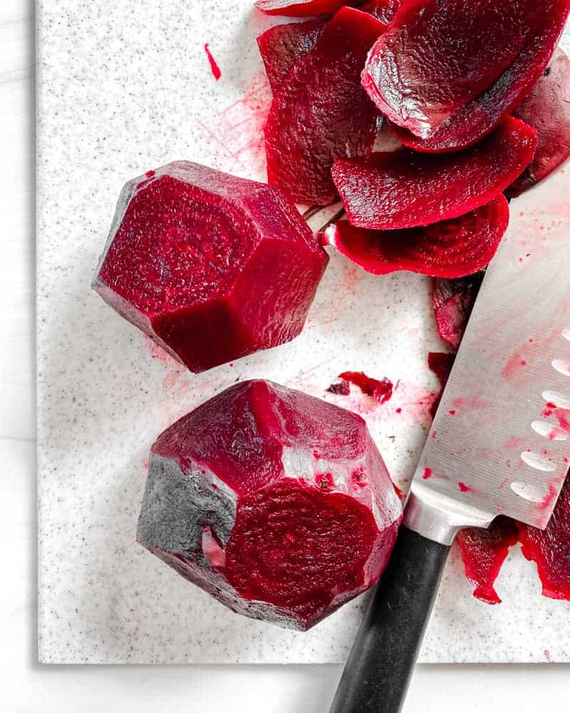 process of slicing beets against a white background