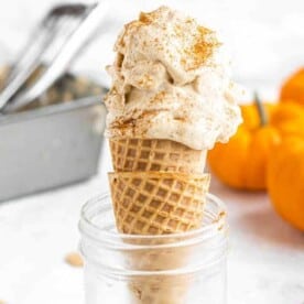 pumpkin ice crema in a cone in a glass jar against a white background