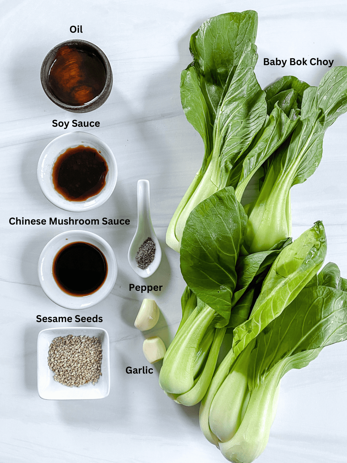 ingredients for Baby Bok Choy with Soy Sauce and Garlic measured out on a white surface