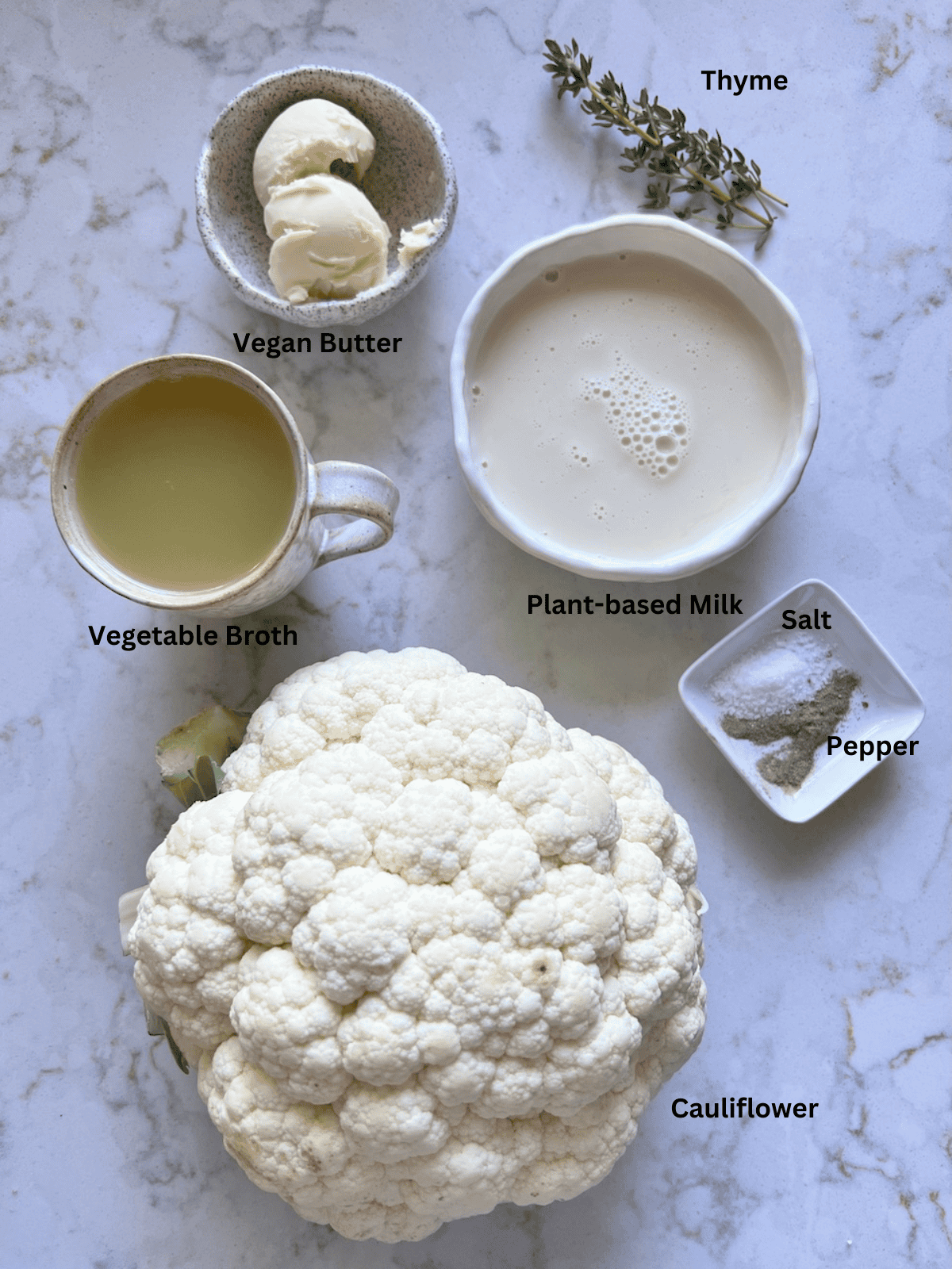 ingredients for mashed cauliflower measured out against a white surface