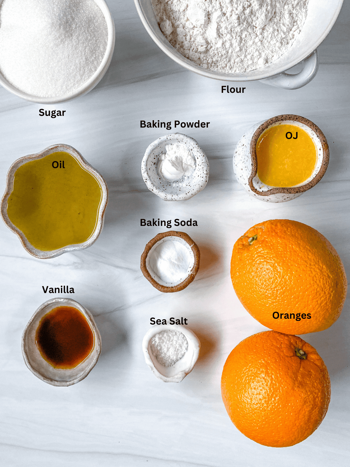 ingredients for Orange Olive Oil Cake measured out on a white surface