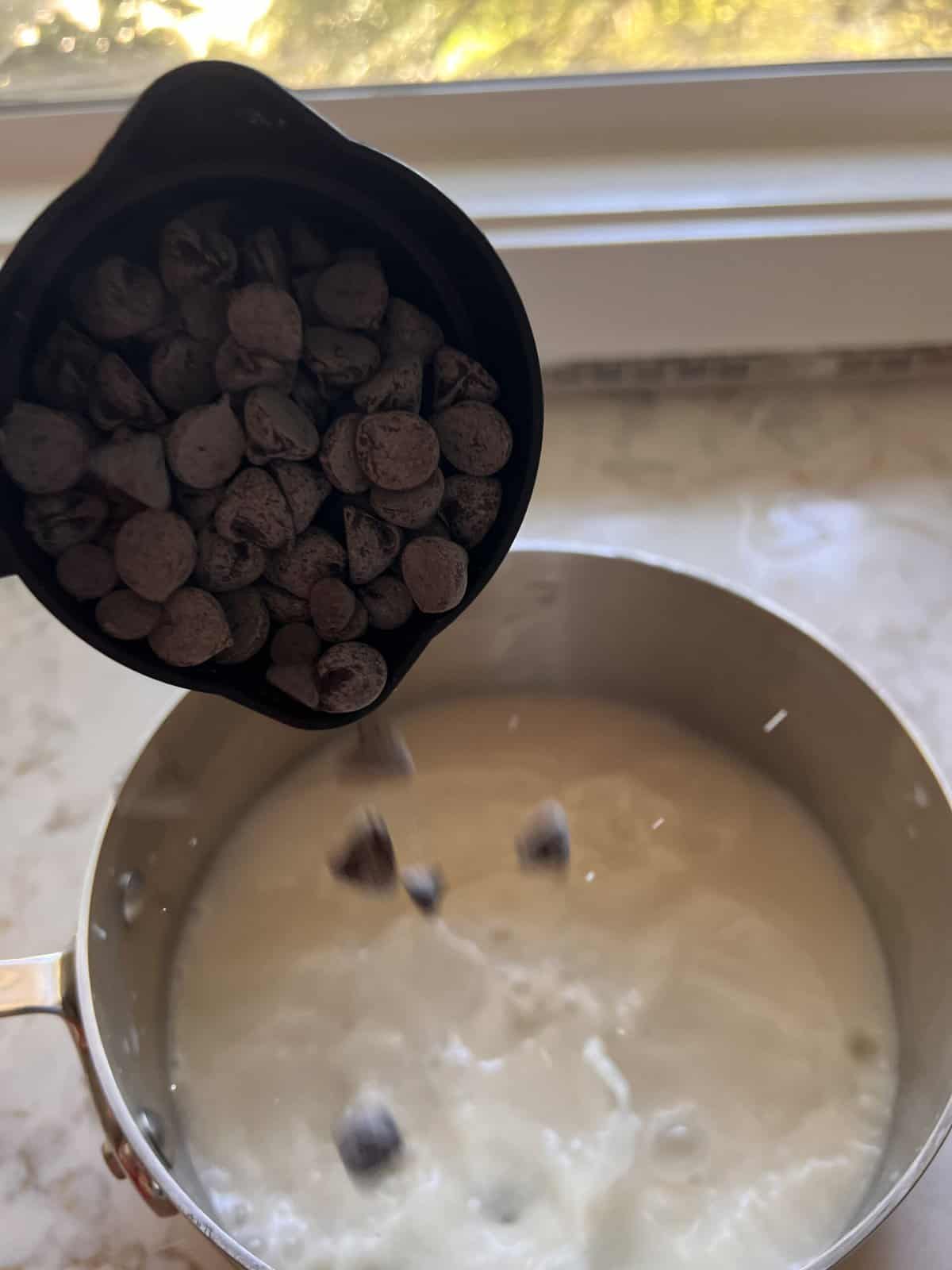process shot of pouring chocolate chips into pan