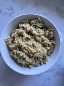process of quinoa being fluffed post cooking