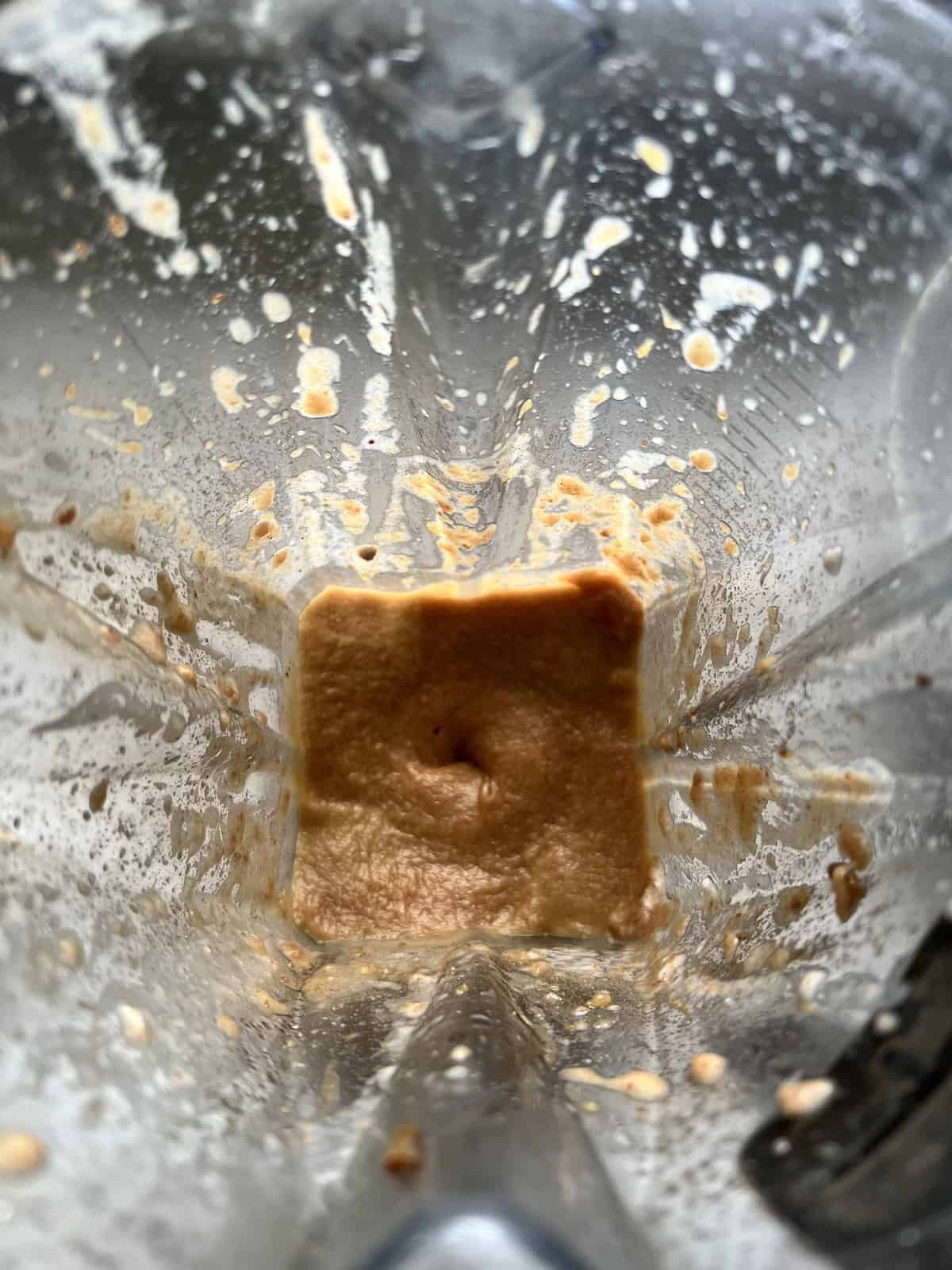 process of blending Homemade Vegan Caramel Sauce ingredients in blender