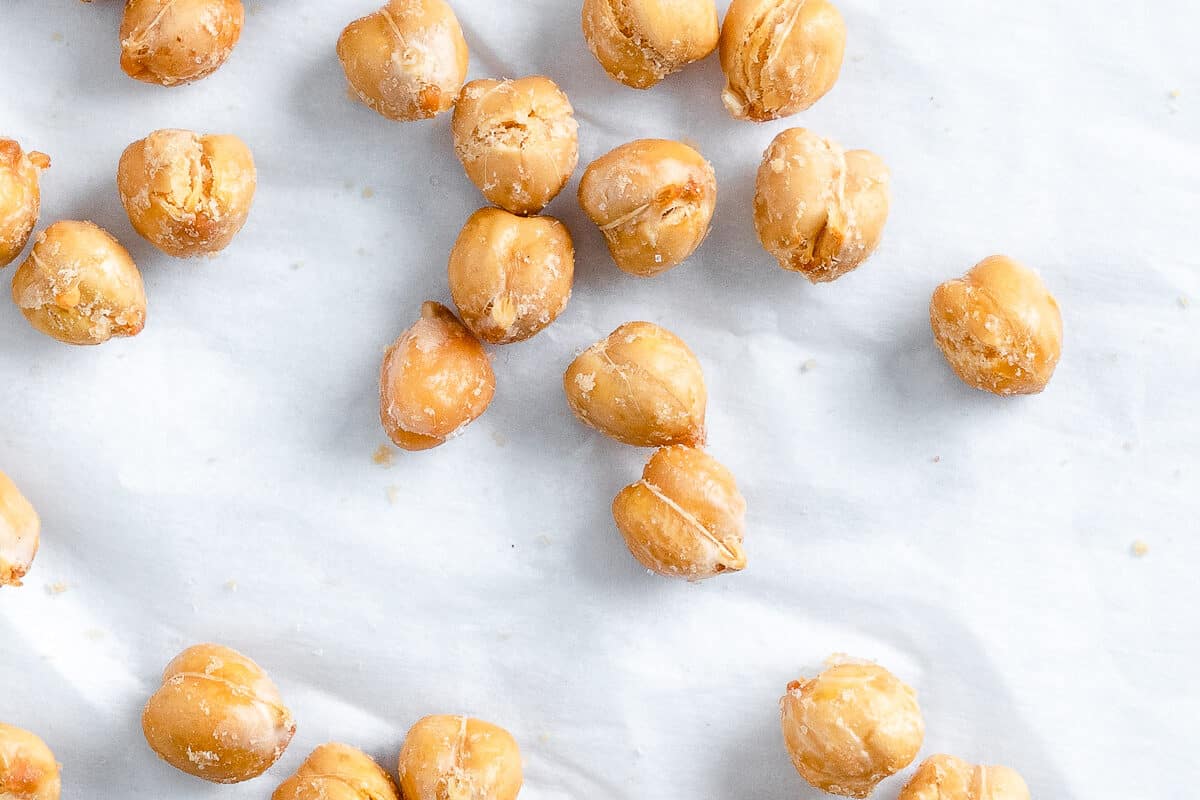 scattered completed air fryer chickpeas on a white surface