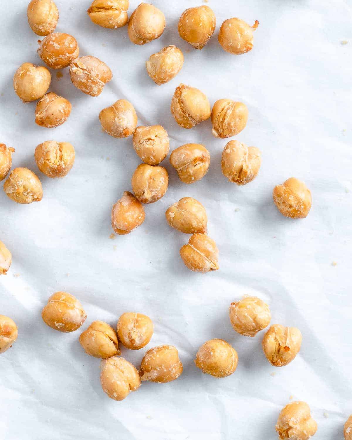 scattered completed air fryer chickpeas on a white surface