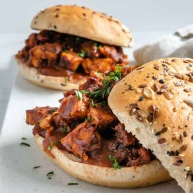 two completed BBQ Tempeh Sandwiches against a white surface
