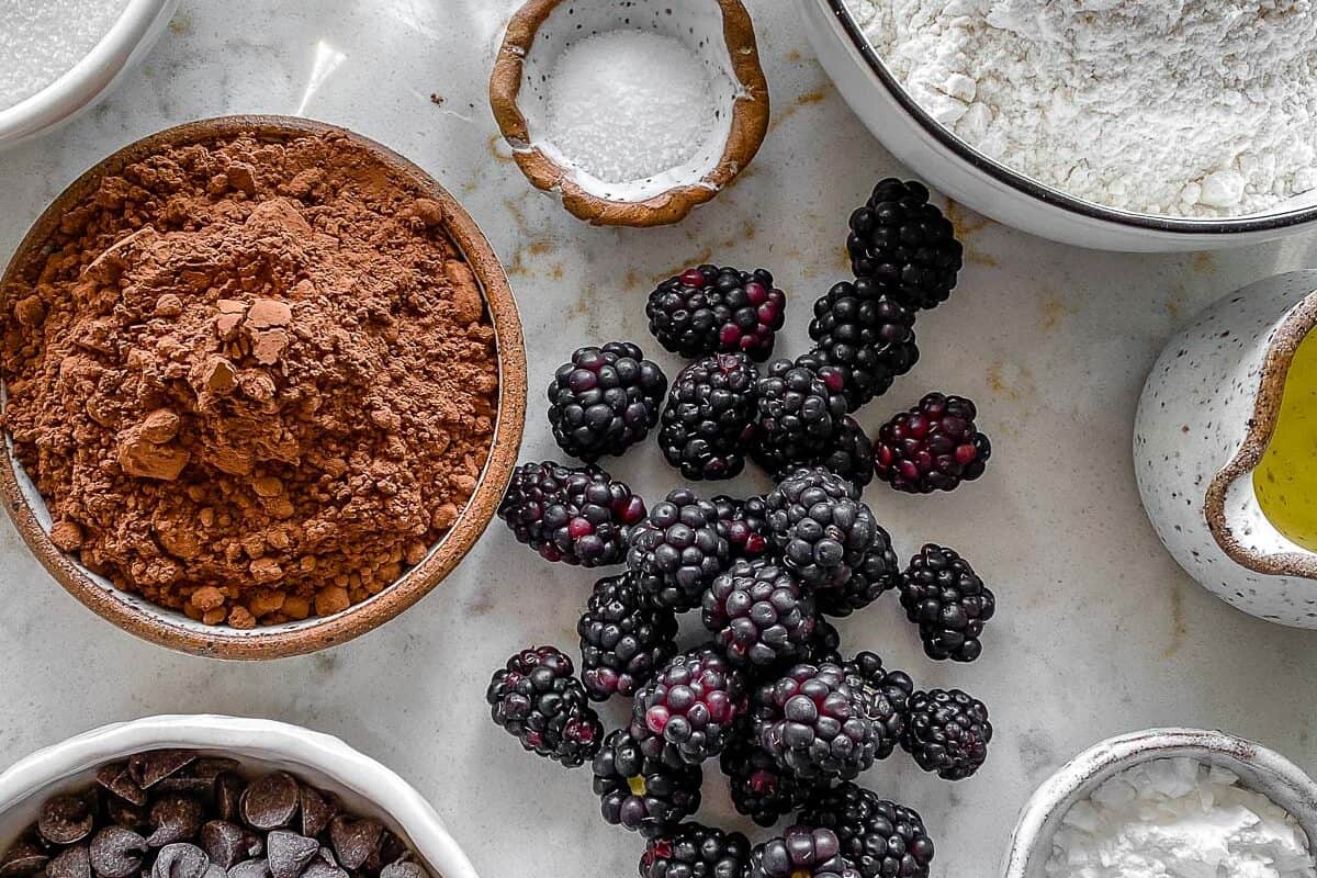 ingredients for Blackberry Chocolate Cupcakes measured out against white surface