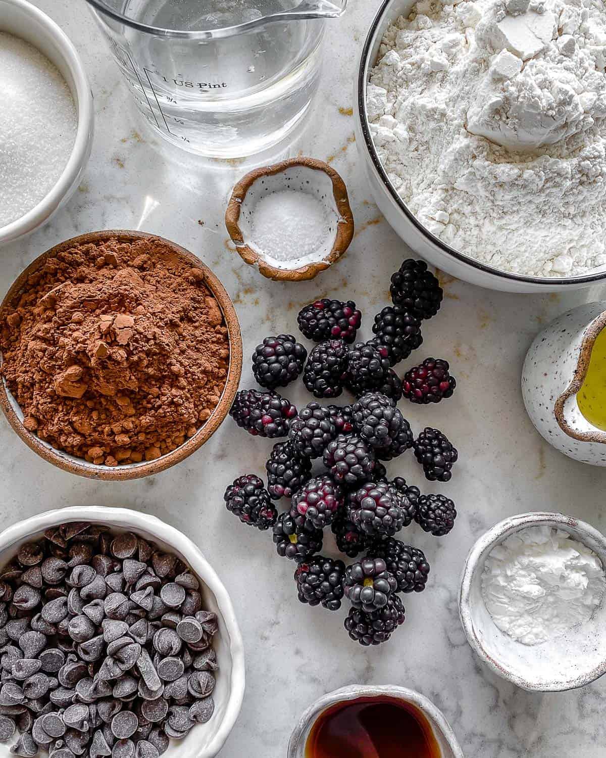ingredients for Blackberry Chocolate Cupcakes measured out against white surface