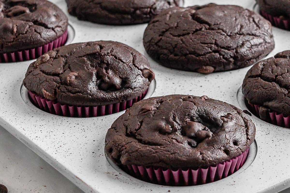 completed Blackberry Chocolate Cupcakes without icing on top in muffin tin