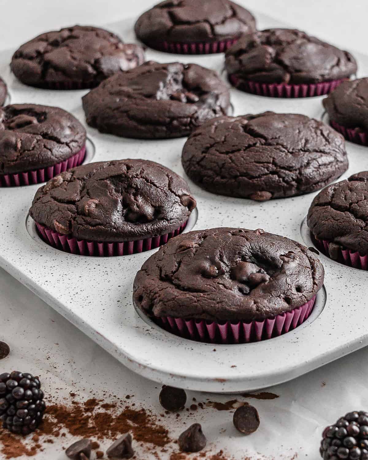 completed Blackberry Chocolate Cupcakes without icing on top in muffin tin