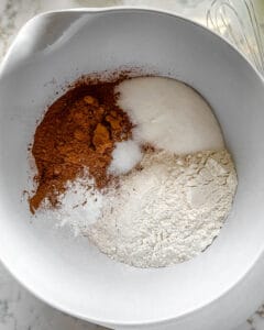 dry ingredients for Blackberry Chocolate Cupcakes in white bowl