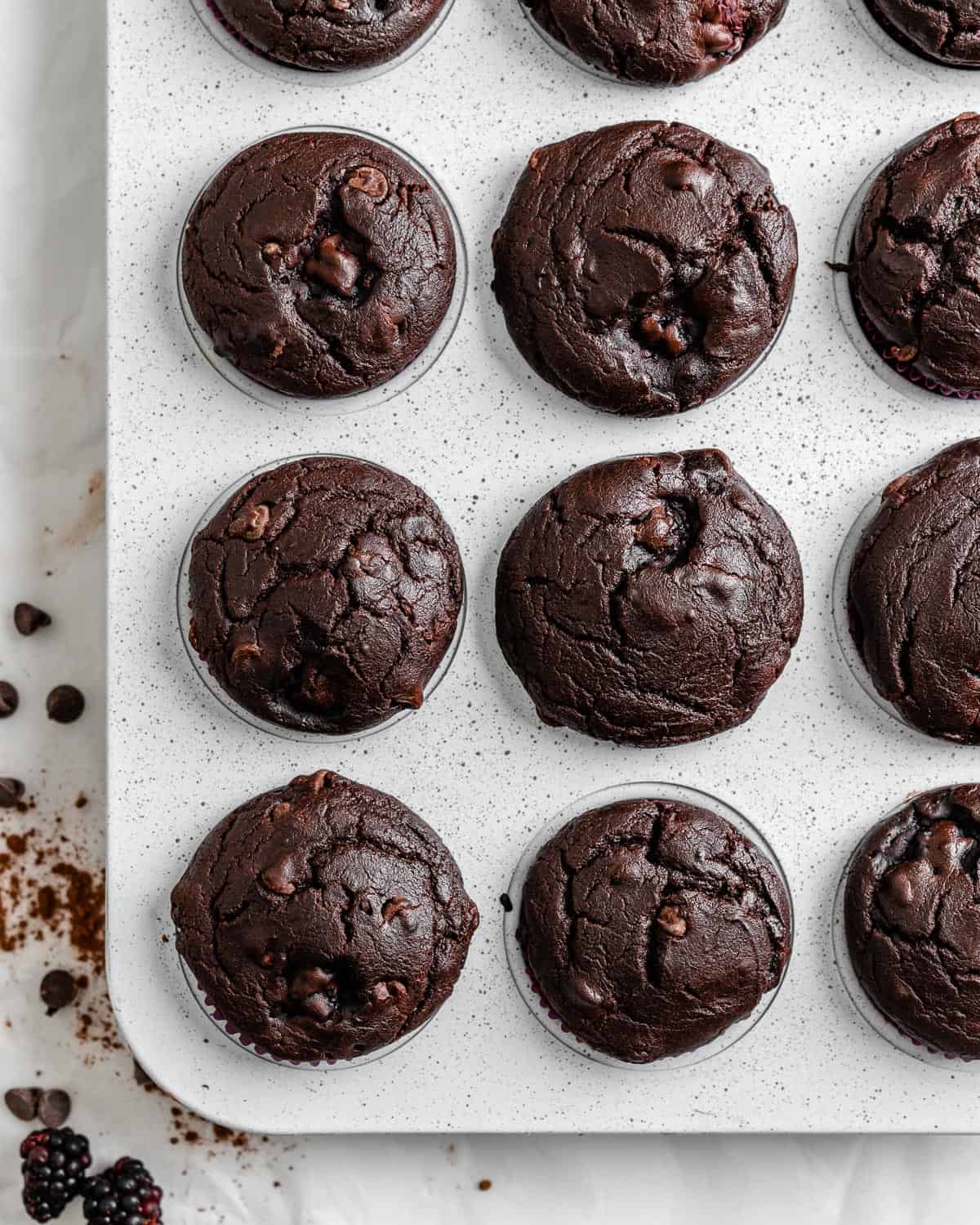 completed Blackberry Chocolate Cupcakes without icing on top in muffin tin