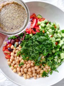 process shot showing adding dressing to bowl