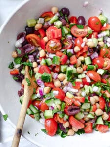 process shot showing mixing salad ingredients together