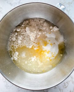 process of showing the mixture of ingredients for lemon loaf in stainless steel bowl