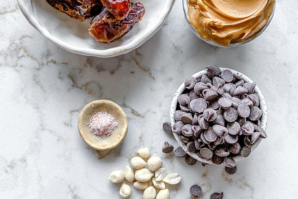 ingredients for stuffed dates measured out on a white surface