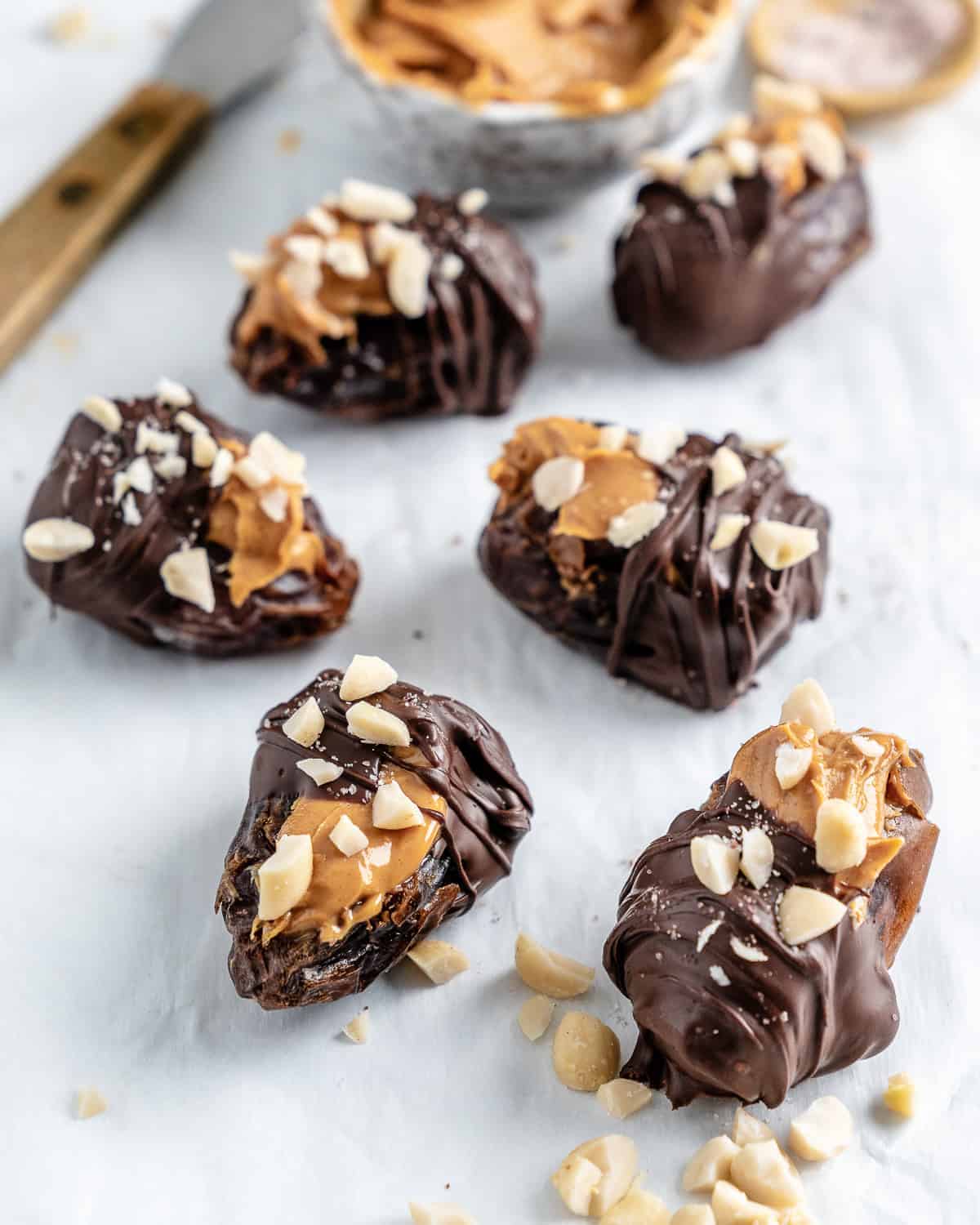 completed peanut butter stuffed dates on a white surface