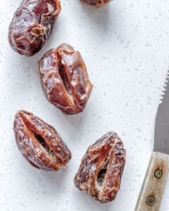 pitted dates on a white surface