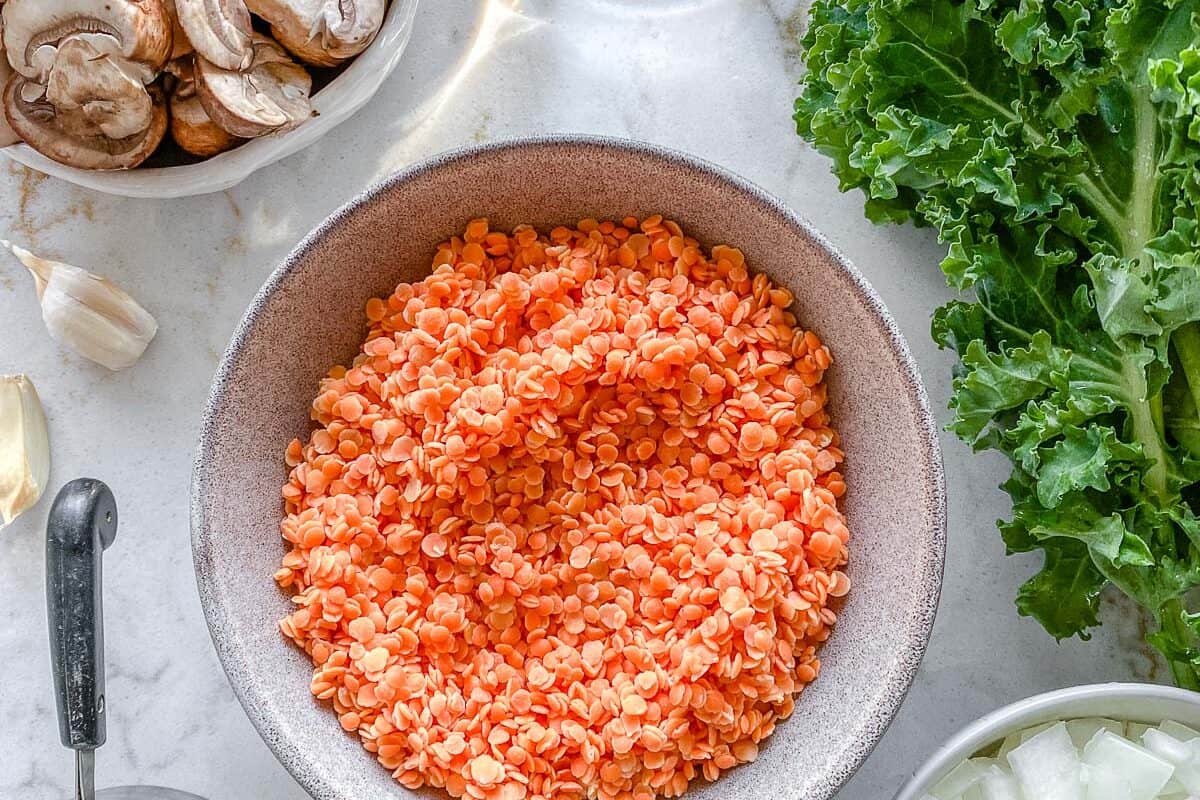 ingredients for Red Lentil Meatballs measured out in individual bowls against white surface