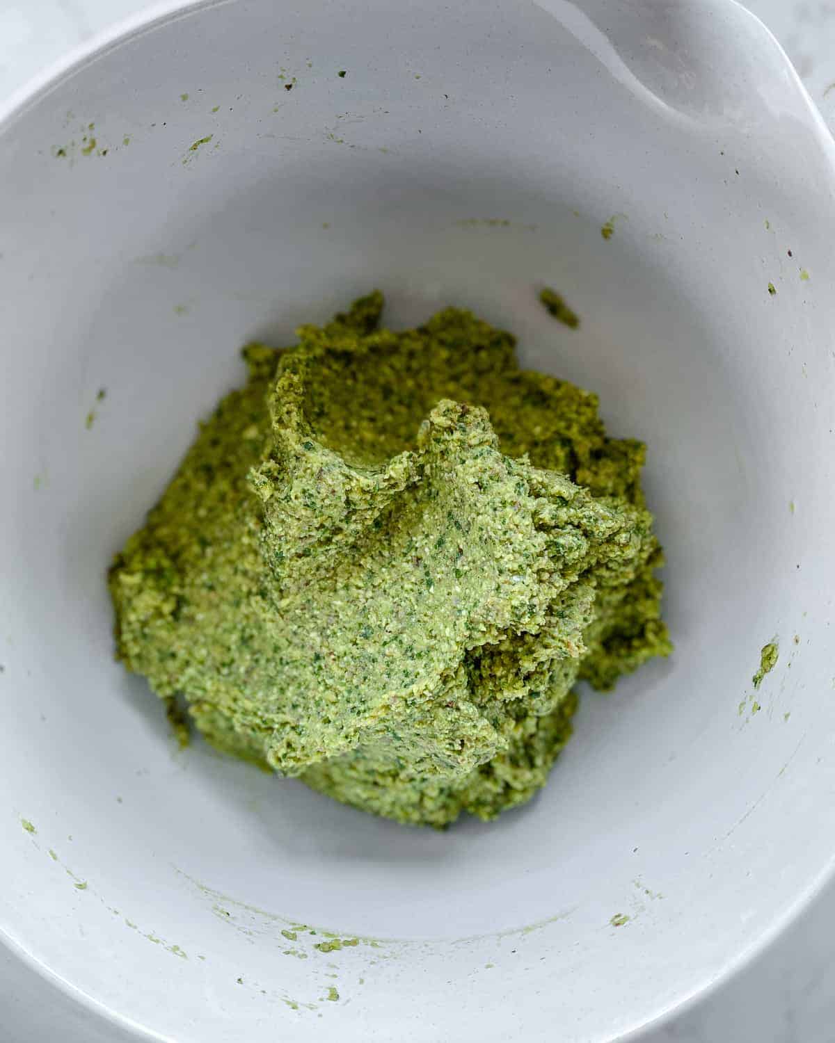 post process of mixing Red Lentil Meatballs mixture together in white bowl