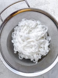process shot showing noodles in strainer