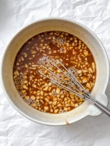 process shot showing stirring sauce in bowl