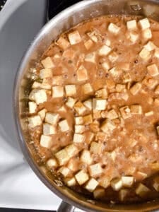 process shot of tofu and sauce cooking in pan
