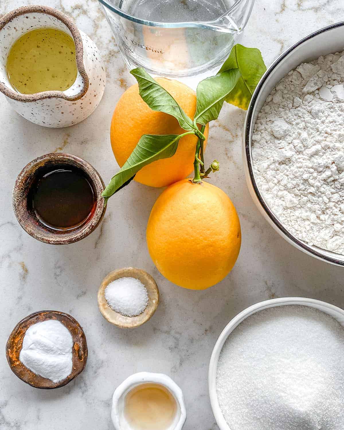 ingredients for lemon cupcakes measured out against a white surface