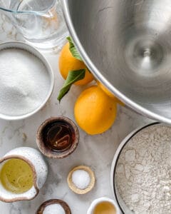 ingredients for lemon cupcakes measured out against a white surface