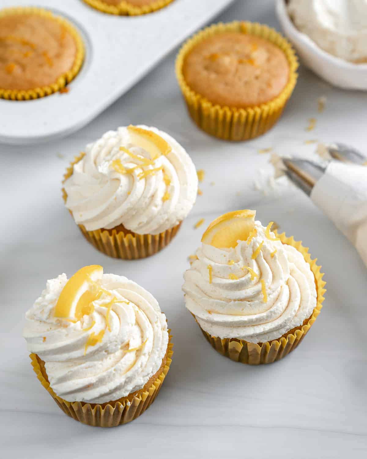 completed lemon vanilla cupcakes on a white surface