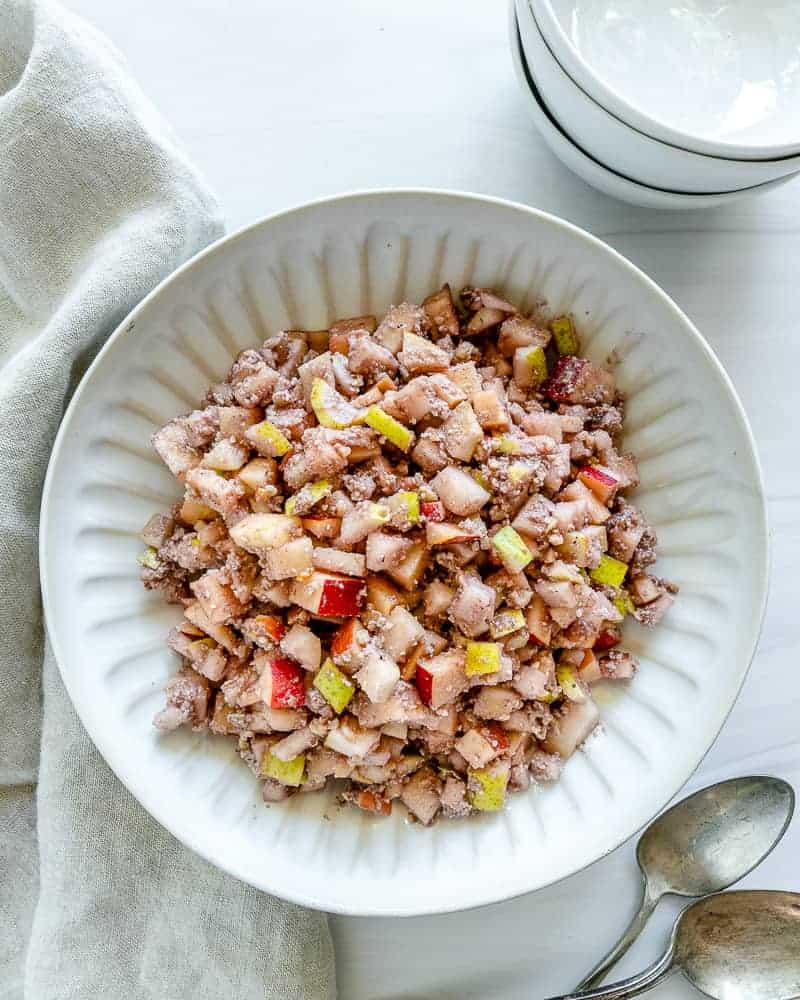 completed chunky charoset in a white plate against a white background