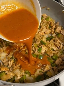 process of adding bbq sauce to pan of jackfruit and veggies