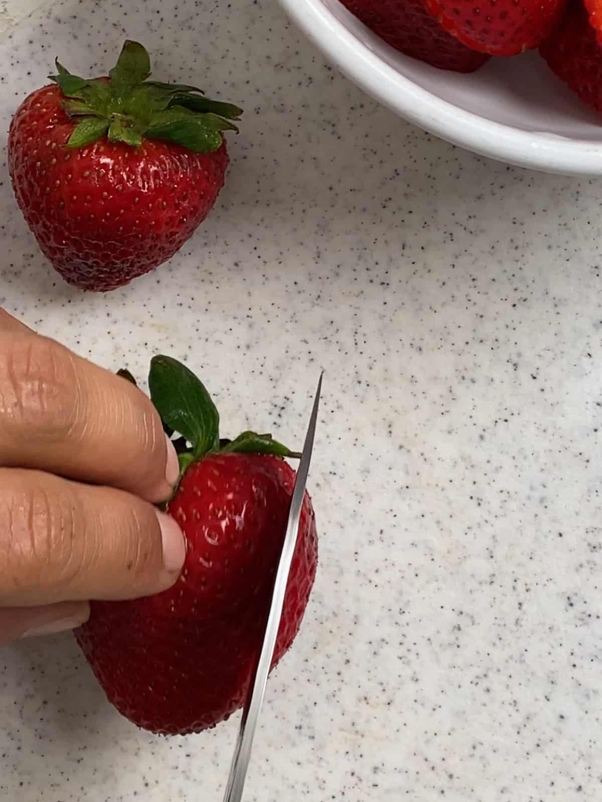 process of cutting strawbberries