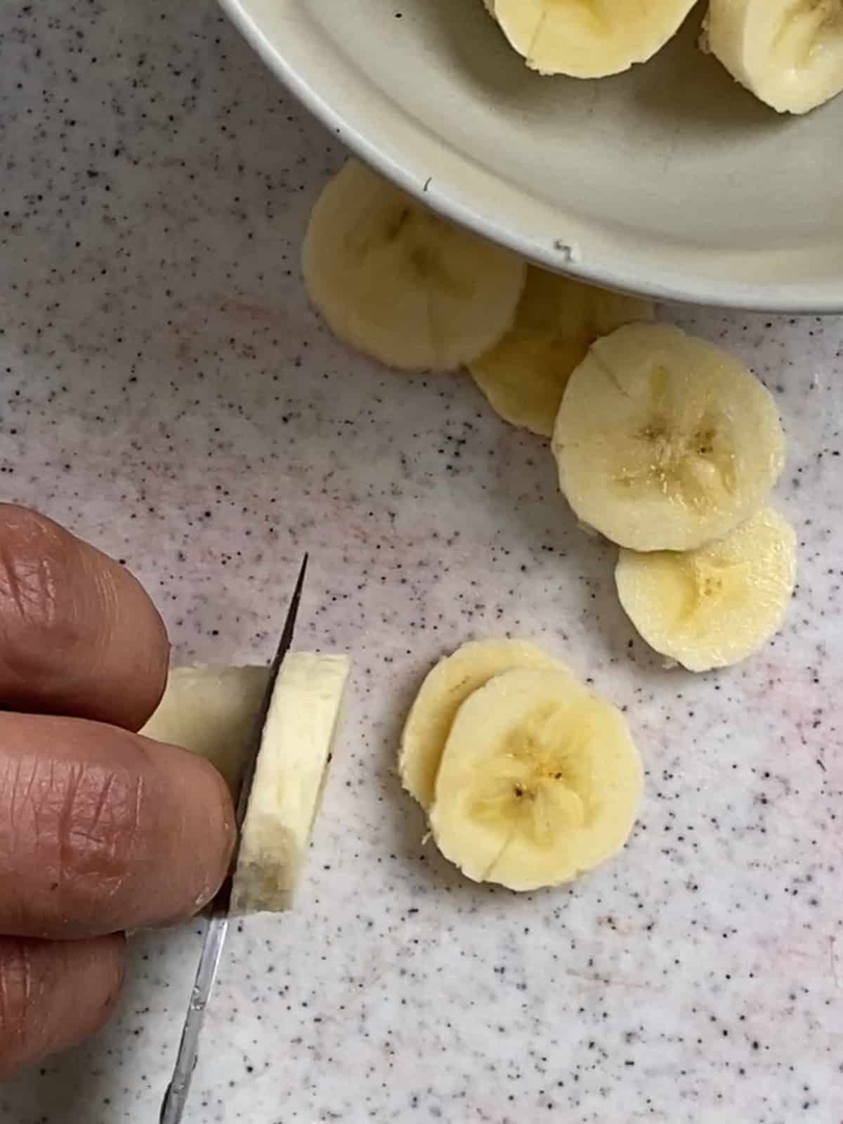 process of cutting bananas into slices