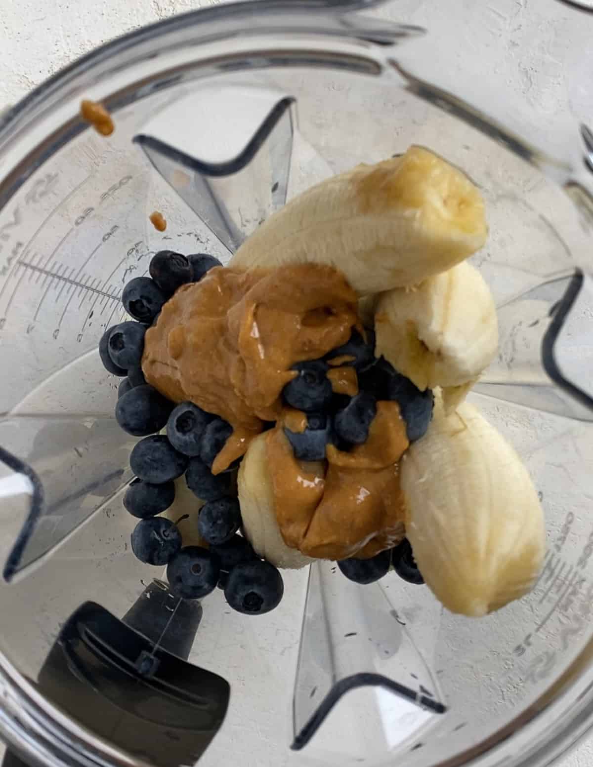 process of adding peanut butter to blender