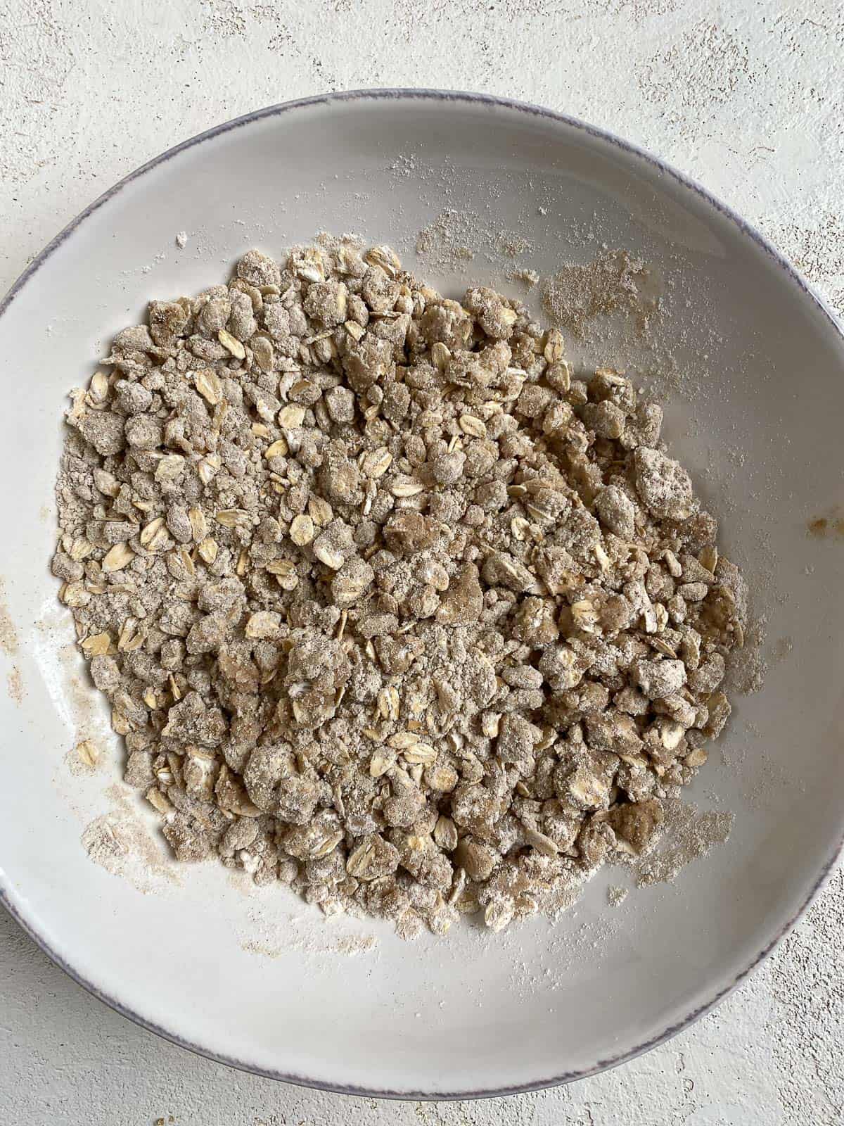 post mixing of crumble topping in a white bowl