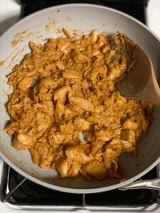 process shot of mixing jackfruit mixture with sauce in pan