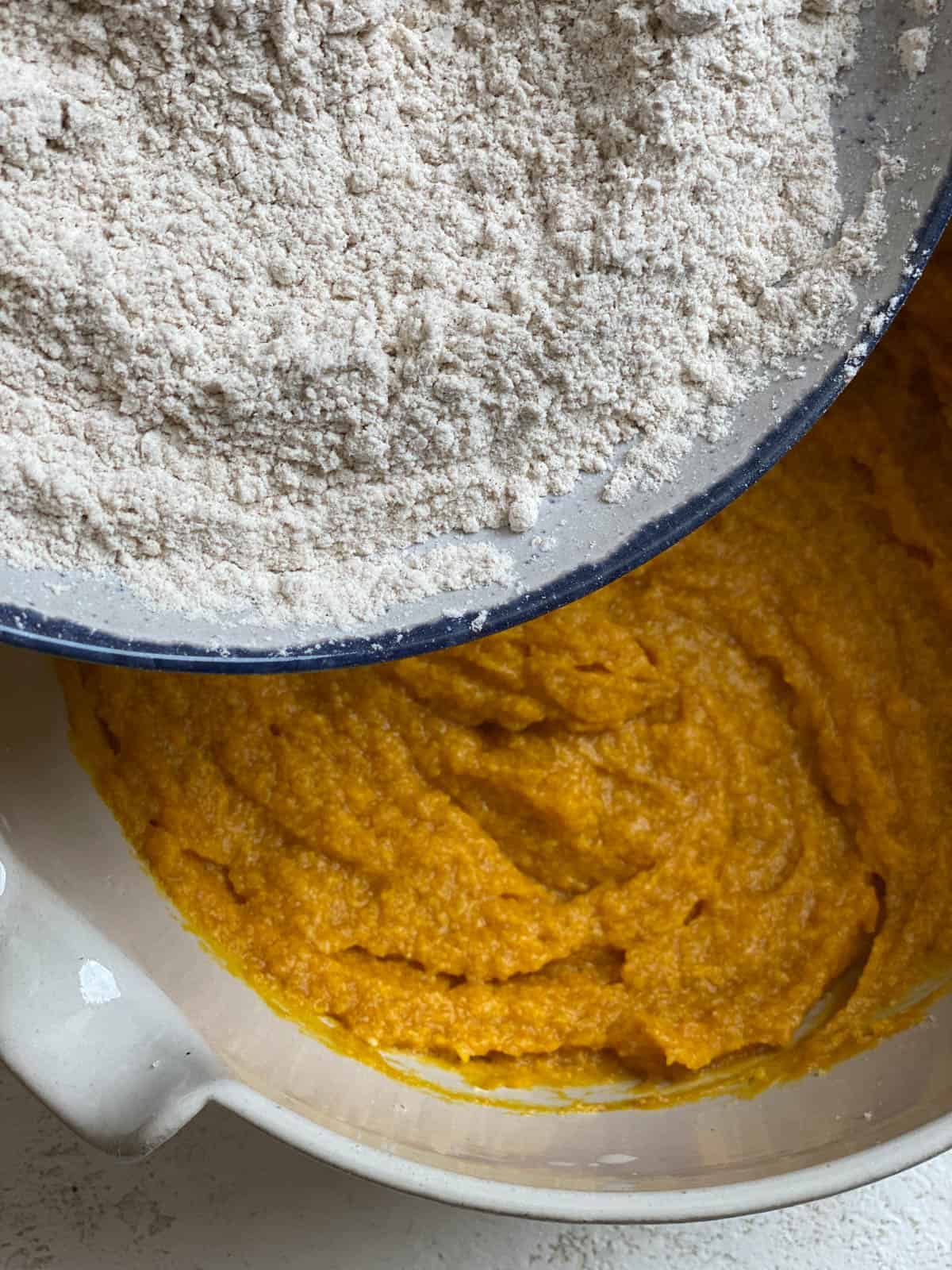process of adding flour to pumpkin mixture