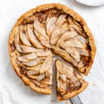 completed Easy Apple Pear Pie with a slice cut out against a white surface