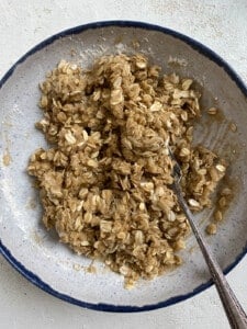process shot showing mixture of Easy Pear Crisp [Vegan Pear Crumble] ingredients in a bowl