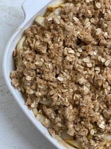 post adding oat filling mixture on top of pear mixture in baking dish