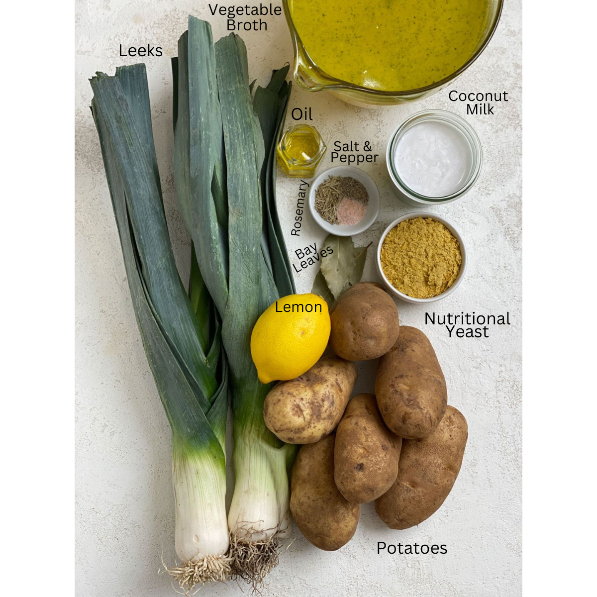 ingredients for Creamy Potato Leek Soup measured out against a white surface