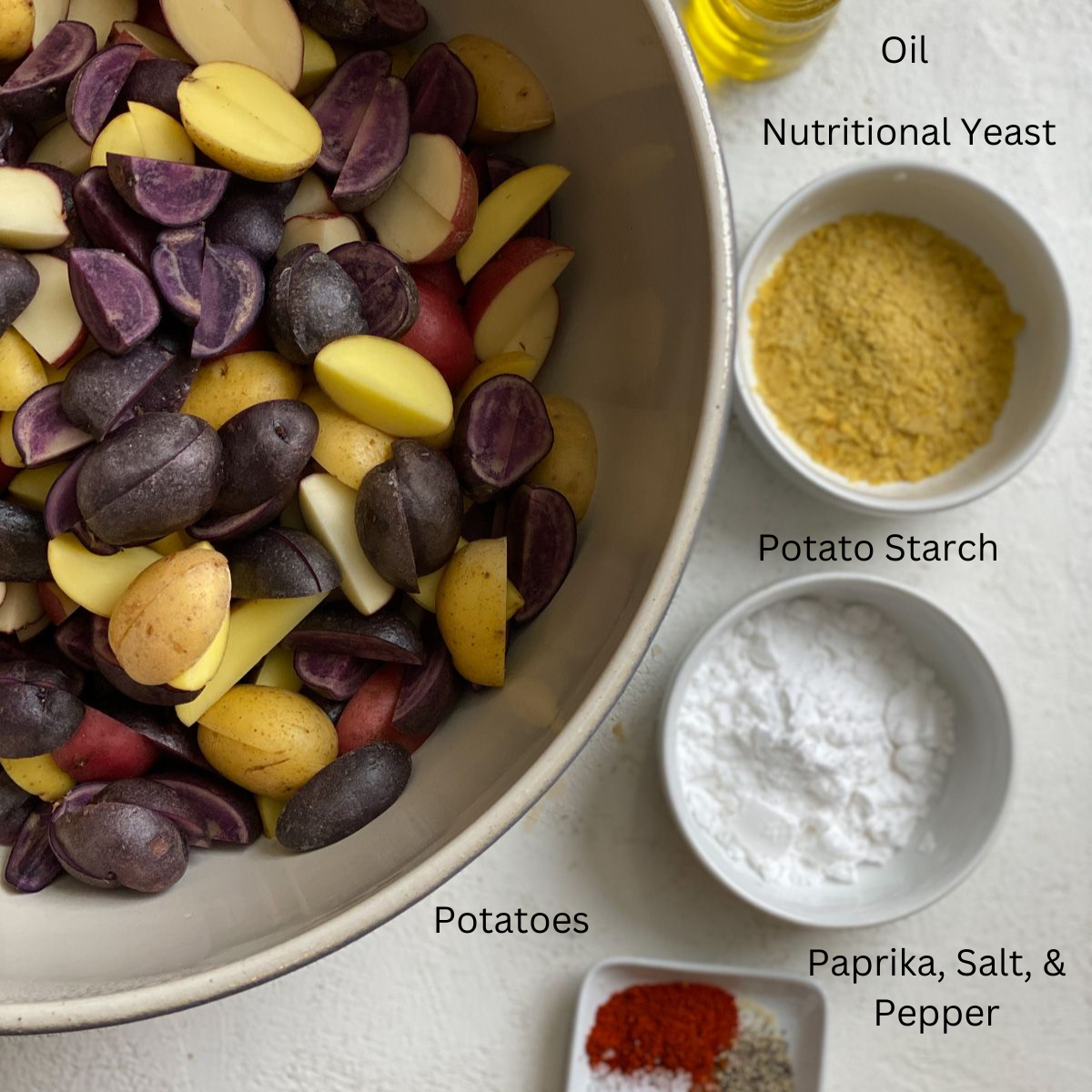 ingredients for Crispy Purple Potatoes Recipe measured out against a white surface