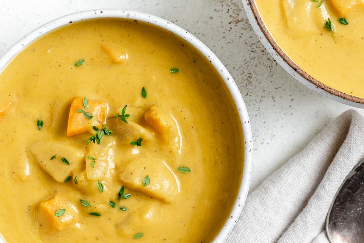 completed Roasted Delicata Squash and Sweet Potato Soup in a white bowl against a light background