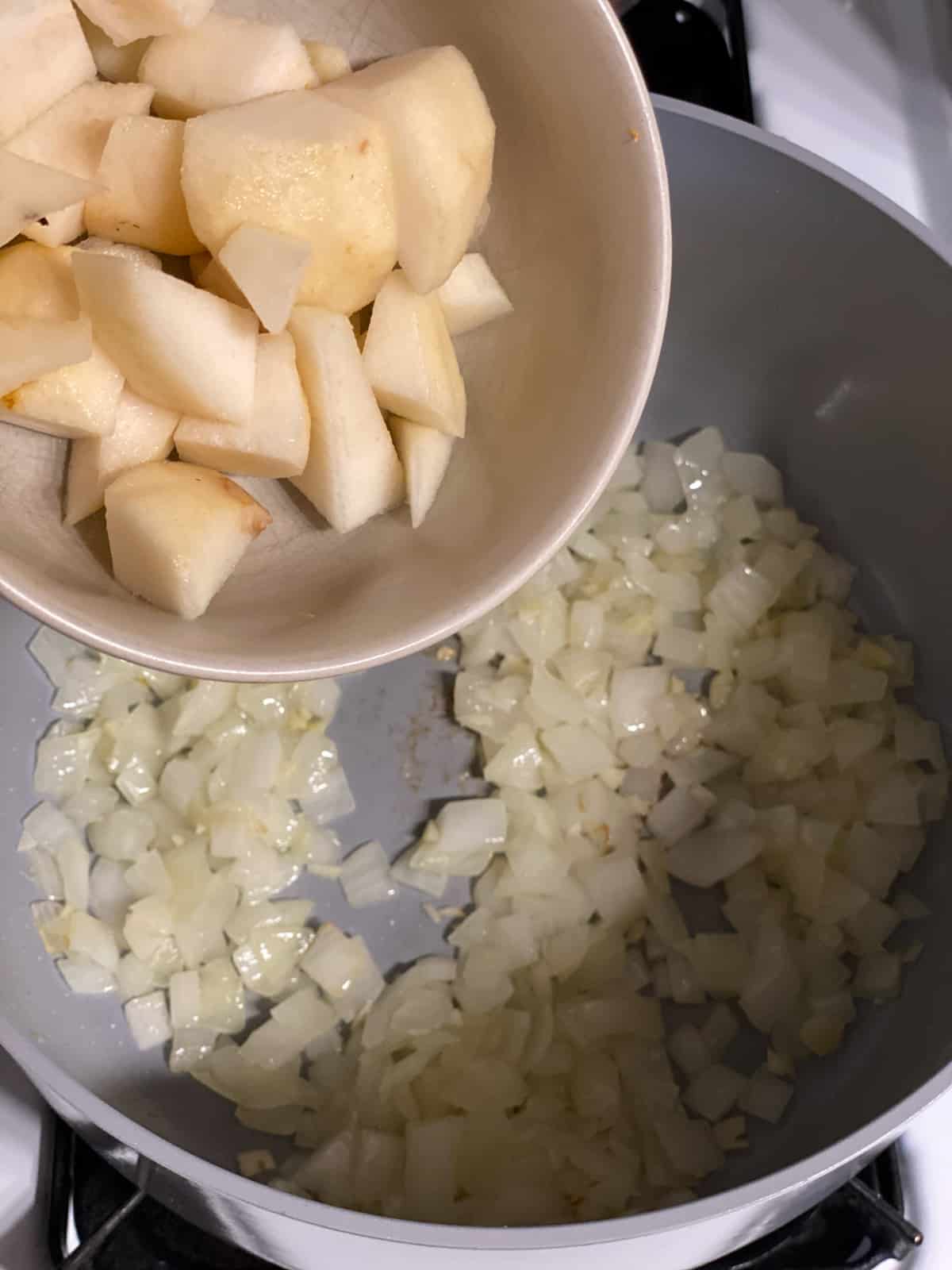 process of adding chopped pear to pan